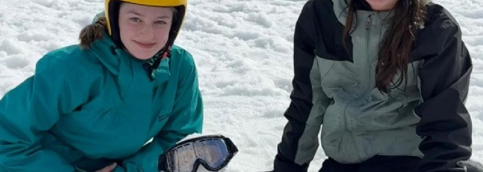 Isca Students making a mini snow man and sat on the snow in Spin